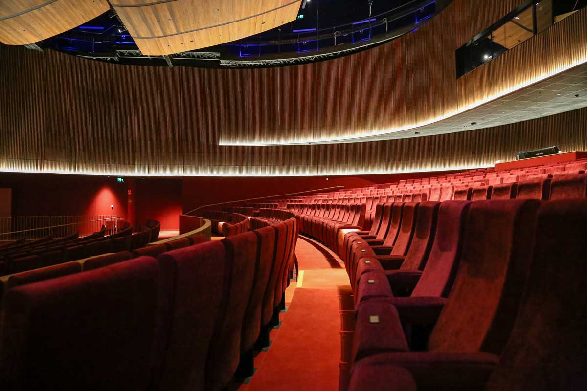 Red fabric seats sit in a modern-looking concert hall, Melbourne's new The Round.